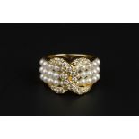 A CULTURED PEARL AND DIAMOND DRESS RING, designed as three rows of uniform cultured pearls, spaced