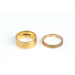 AN 18CT GOLD WEDDING BAND BY KUTCHINSKY, the flat section band engraved with chequerboard