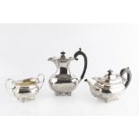 A SILVER THREE PIECE TEA SERVICE, with gadrooned and foliate cast borders, on scroll and paw feet,