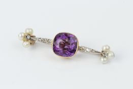 AN AMETHYST, PEARL AND DIAMOND BROOCH, centred with a cushion-shaped amethyst in millegrain collet