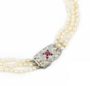 A CULTURED PEARL TRIPLE STRAND NECKLACE WITH RUBY AND DIAMOND SET CLASP, comprising three strands of