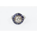 A DIAMOND AND SAPPHIRE CLUSTER RING, the principal old brilliant-cut diamond claw set within an