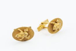 A PAIR OF CUFFLINKS, each modelled as a frog perched on a lily pad, on hinged baton fittings, yellow