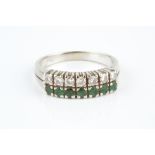 AN EMERALD AND DIAMOND HALF HOOP RING, designed as two rows of circular mixed-cut emeralds and round
