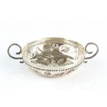 AN EARLY 20TH CENTURY BRITANNIA STANDARD SILVER TASTE VIN, embossed with a flowerhead and foliage,