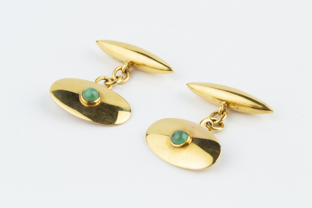 A PAIR OF EMERALD SET CUFFLINKS, each oval panel centred with a circular cabochon emerald in