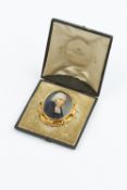 AN EARLY VICTORIAN PORTRAIT MINIATURE MEMORIAL BROOCH, the oval ivory panel painted to depict the