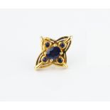 A SAPPHIRE SET TIE PIN, the quatrefoil-shaped panel centred with an oval mixed-cut sapphire in