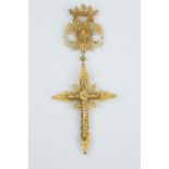 AN ORNAMENTAL FILIGREE CROSS PENDANT, the ornate cross suspended from a double headed eagle with