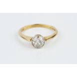 A DIAMOND SINGLE STONE RING, the old-cut diamond in millegrain collet setting, 18ct two colour