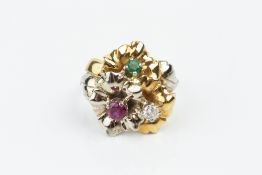 A VARI GEM-SET DRESS RING, modelled as three entwined flowerheads, individually centred with a round