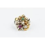 A VARI GEM-SET DRESS RING, modelled as three entwined flowerheads, individually centred with a round