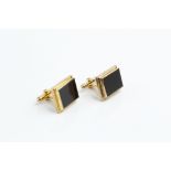 A PAIR OF ONYX CUFFLINKS, each rectangular black onyx panel in collet setting, on hinged baton