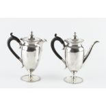 A SILVER BACHELOR'S COFFEE POT, and matching hot milk pot, of urn form, with gadrooned borders,