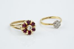 A RUBY AND DIAMOND CLUSTER RING, modelled as a stylized flowerhead, the central round brilliant-