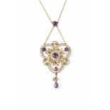 AN EDWARDIAN AMETHYST AND HALF PEARL PENDANT NECKLACE, the openwork scrolled trefoil panel centred
