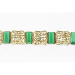 AN AUSTRIAN GREEN AGATE PANEL BRACELET, designed as a line of shaped octagonal panels, each with