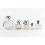 AN EDWARDIAN SILVER TOPPED CUT GLASS SCENT BOTTLE, repoussé decorated with stylised scrolling