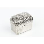 A LATE VICTORIAN SILVER RECTANGULAR BOX AND COVER, the domed cover repoussé decorated with a