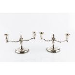 A PAIR OF MEXICAN SILVER TWIN BRANCH CANDELABRA, with shaped arms, flared nozzles, baluster stems