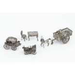 A LATE VICTORIAN SILVER MINIATURE MODEL OF A TABLE, with matching chair, embossed with cherubs and