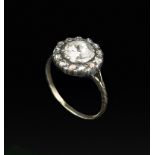 A 19TH CENTURY DIAMOND CLUSTER RING, the principal rose-cut diamond bordered by a row of smaller