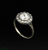 A 19TH CENTURY DIAMOND CLUSTER RING, the principal rose-cut diamond bordered by a row of smaller