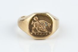 A 9CT GOLD SIGNET RING, the octagonal panel incised with a boar and arrow crest, hallmarked for