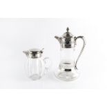A LATE VICTORIAN SILVER MOUNTED GLASS CLARET JUG, the hinged cover with pineapple finial, having
