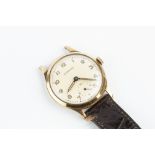 A GENTLEMAN'S 9CT GOLD WATCH HEAD BY GARRARD, the circular signed dial with Arabic numerals and