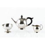 A VICTORIAN SCOTTISH SILVER THREE PIECE BACHELOR'S TEA SET, the globular teapot with ebonised handle