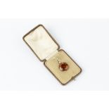 A CITRINE AND DIAMOND PENDANT, the circular mixed-cut citrine claw set below a cushion-shaped old-