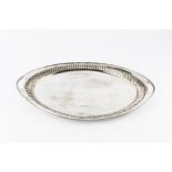 A LATE VICTORIAN SILVER OVAL TWIN HANDLED TEA TRAY, with reeded edge and gadrooned border, by