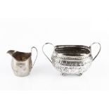 A GEORGE III SILVER TWIN HANDLED SUCRIER, embossed and engraved with flowers and scrolling