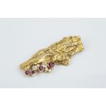 A RUBY AND DIAMOND SET PANEL BROOCH BY TERRY WALDRON, the abstract bark textured panel highlighted