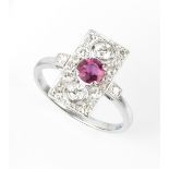 A PINK TOURMALINE AND DIAMOND PANEL RING, the rectangular pierced and millegrain panel centred