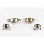 A PAIR OF GEORGE III SILVER CIRCULAR SALTS, on stepped pad feet, maker I.W., London 1760; and a pair