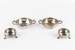 A PAIR OF GEORGE III SILVER CIRCULAR SALTS, on stepped pad feet, maker I.W., London 1760; and a pair