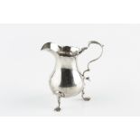 A GEORGE II SILVER BALUSTER CREAM JUG, of plain design, with scroll handle and pad feet, maker W.