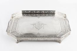 A LATE VICTORIAN SILVER TEA TRAY, of chamfered rectangular form, with pierced gallery, twin