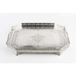 A LATE VICTORIAN SILVER TEA TRAY, of chamfered rectangular form, with pierced gallery, twin