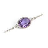 AN AMETHYST AND DIAMOND CLUSTER BAR BROOCH, centred with an oval mixed-cut amethyst bordered by