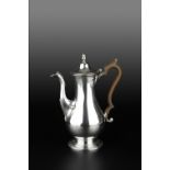 A GEORGE III SILVER COFFEE POT, the baluster body with hinged cover and acorn finial, and having