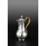 A GEORGE III SILVER HOT MILK POT, of spirally fluted baluster form, with gadrooned hinged cover, and