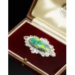 A BLACK OPAL AND DIAMOND CLUSTER PANEL BROOCH, the oval cabochon black opal collet set within a