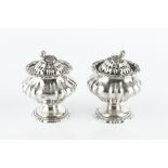 A PAIR OF MID 19TH CENTURY INDIAN COLONIAL SILVER CASTORS, of lobed, squat baluster form, with shell