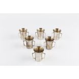 A SET OF SIX SILVER SMALL BEAKERS, each of flared form, with three handles, by Adie Bros Ltd,