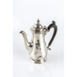 A SILVER BACHELOR'S COFFEE POT, of baluster form, with ebonised handle, by Goldsmiths & Silversmiths
