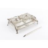 A LATE VICTORIAN SILVER INKSTAND, with shaped and pierced decorated three quarter gallery, fitted