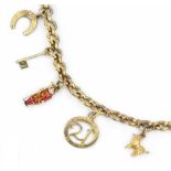 A CHARM BRACELET, the belcher-link bracelet stamped '9 .375', suspending a collection of 9ct gold